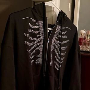 Black hoodie with gem skeleton rib design.